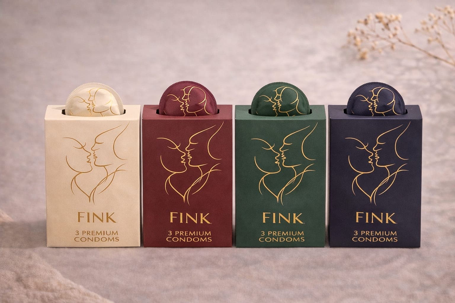Four Fink 3 Premium Condoms boxes in cream, burgundy, green, and navy with matching sachets visible at the top.